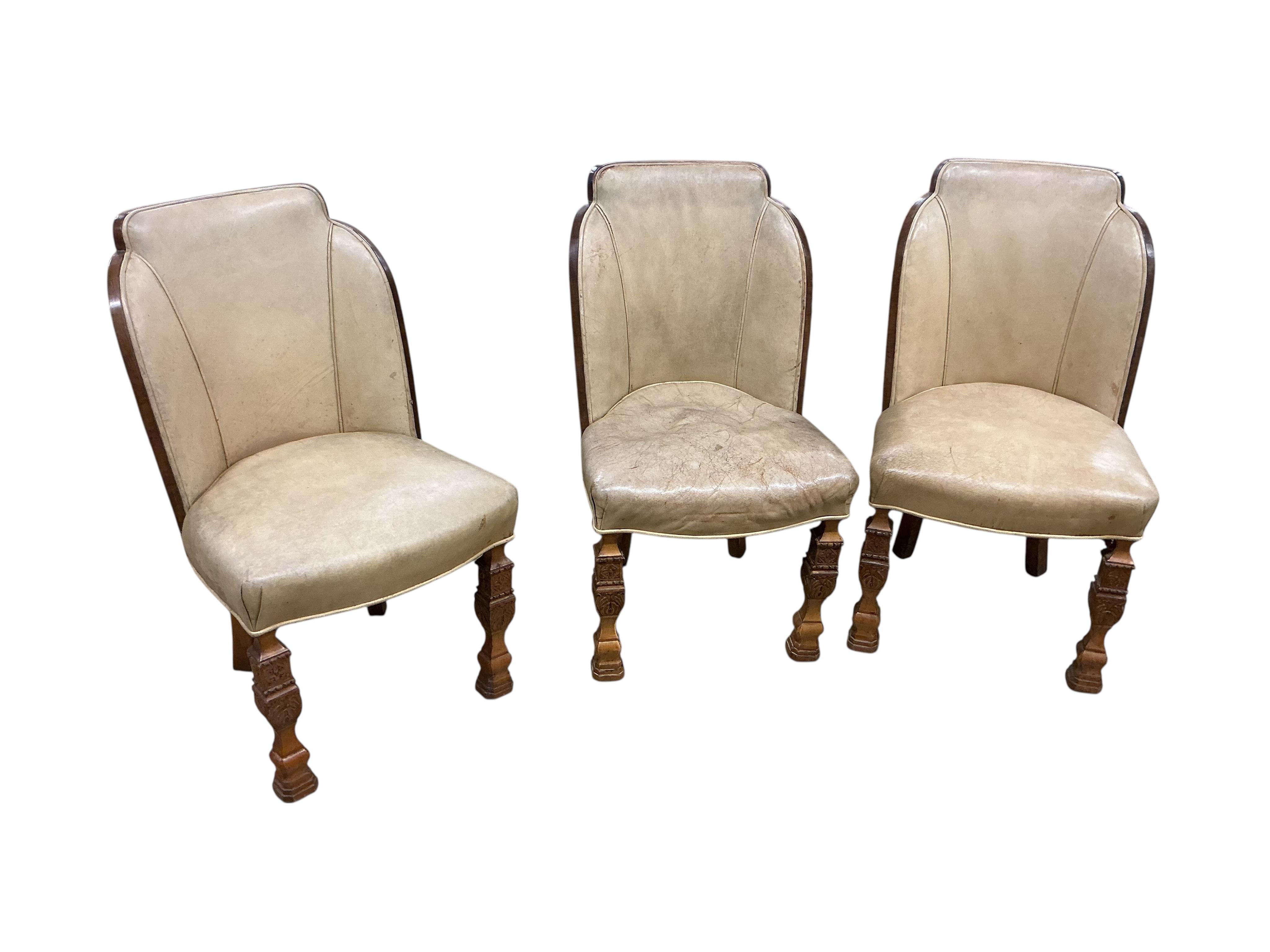 An Art deco walnut dining suite, comprising: dining table, width 190cm, depth 110cm, height 80cm together with eight chairs (two being carvers) and a bow front sideboard